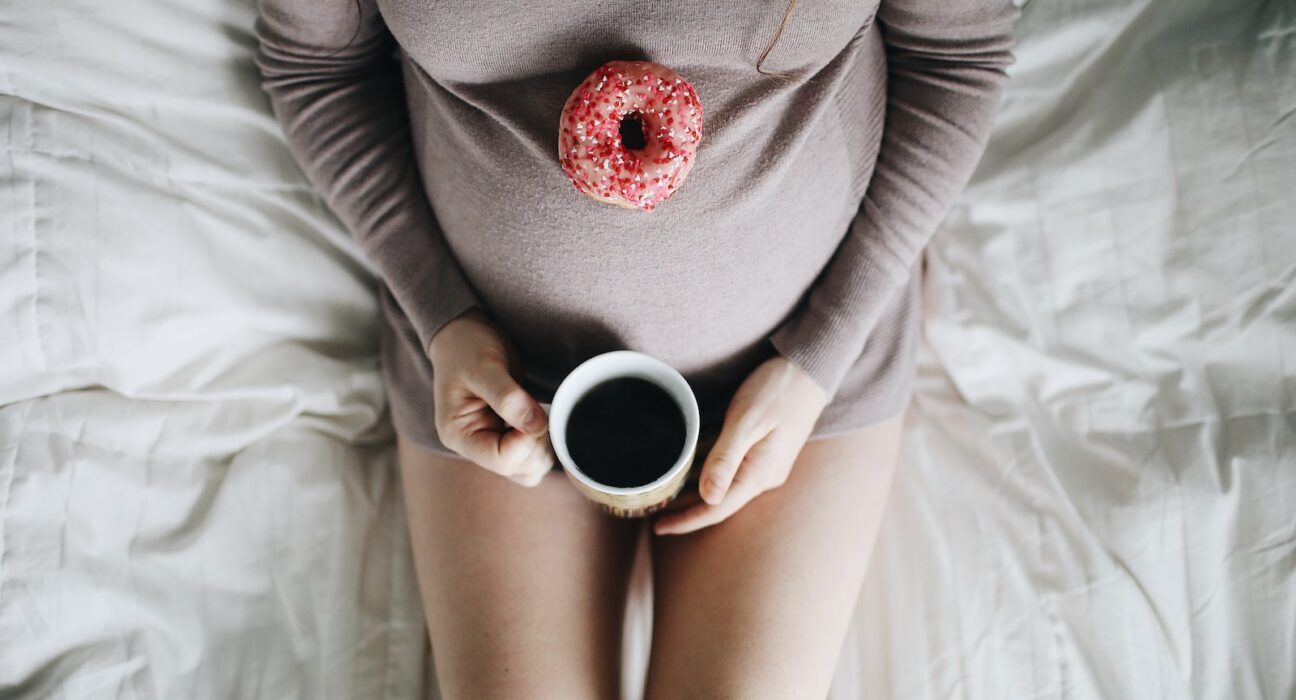 woman holding cup of coffee