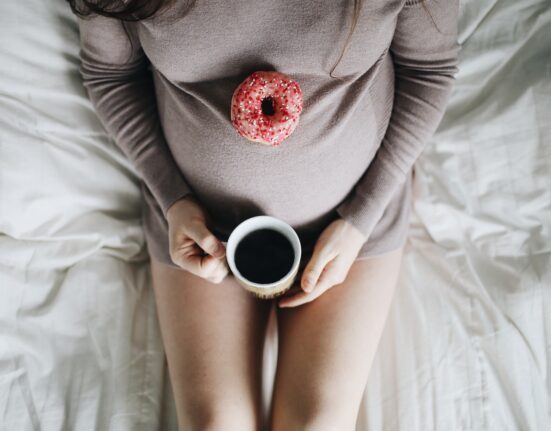 woman holding cup of coffee