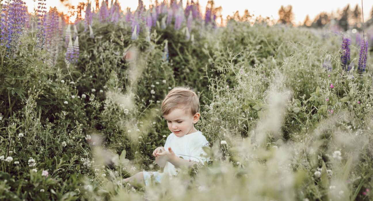 child surrounded by plants