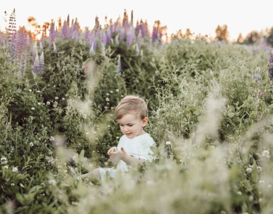 child surrounded by plants