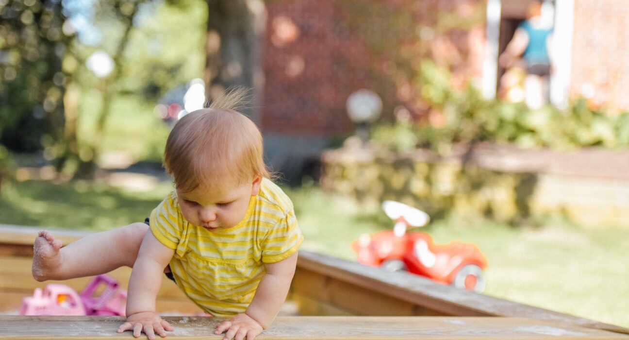 baby trying to get out of his crib