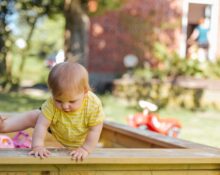 baby trying to get out of his crib